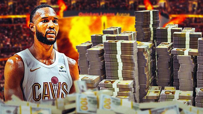 Cavs player Evan Mobley looking at a pile of money.